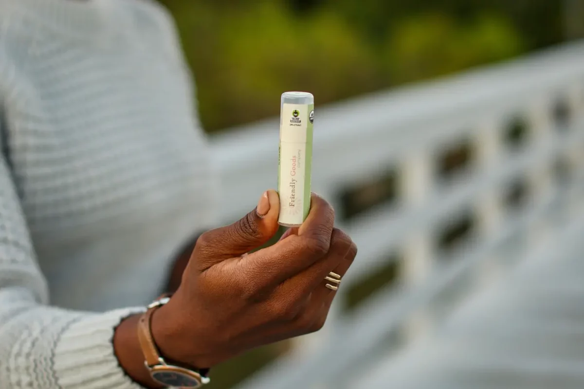 Friendly goods organic lip balm being held up close to the camera