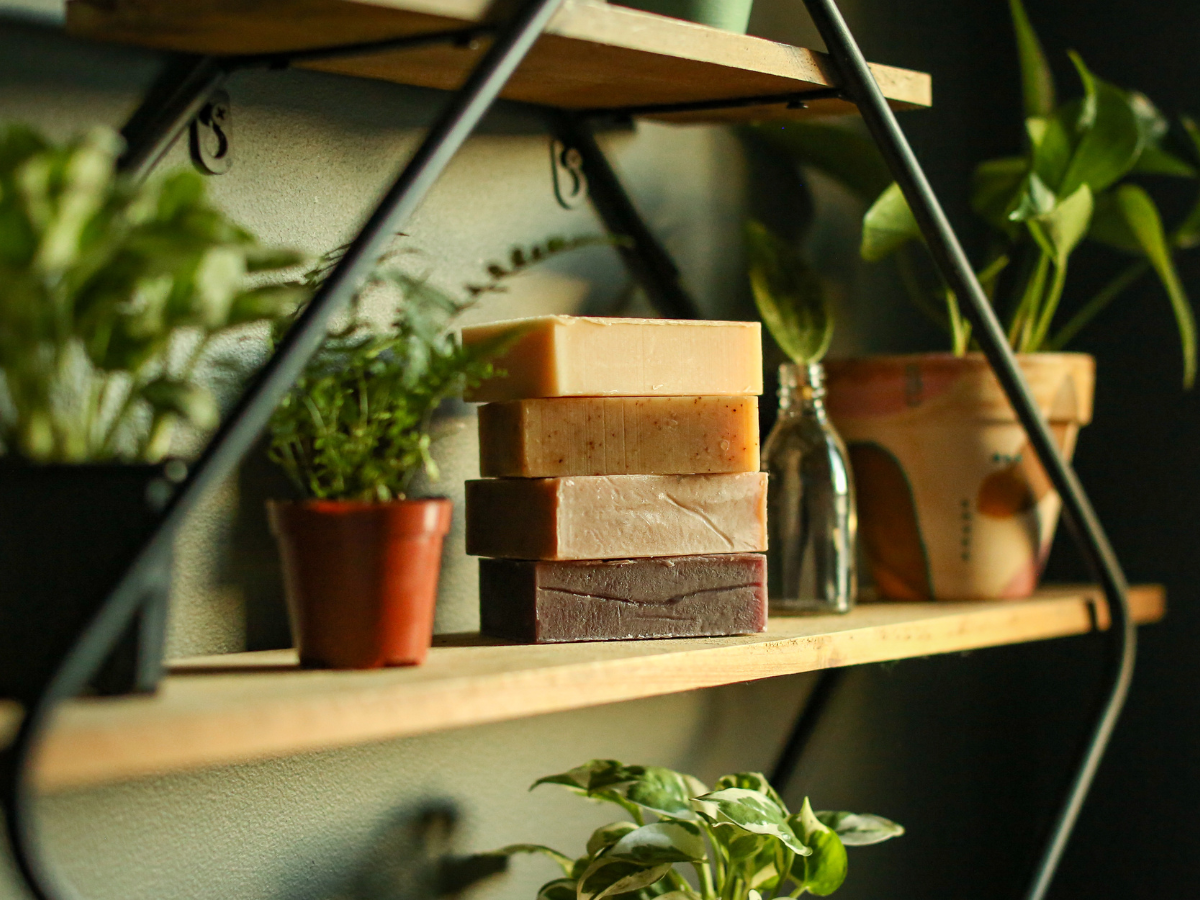 Friendly Goods Company soaps stacked on a shelf with plants