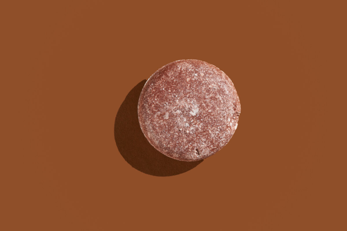 Coconut Moonlight solid Shampoo Bar against a brown background